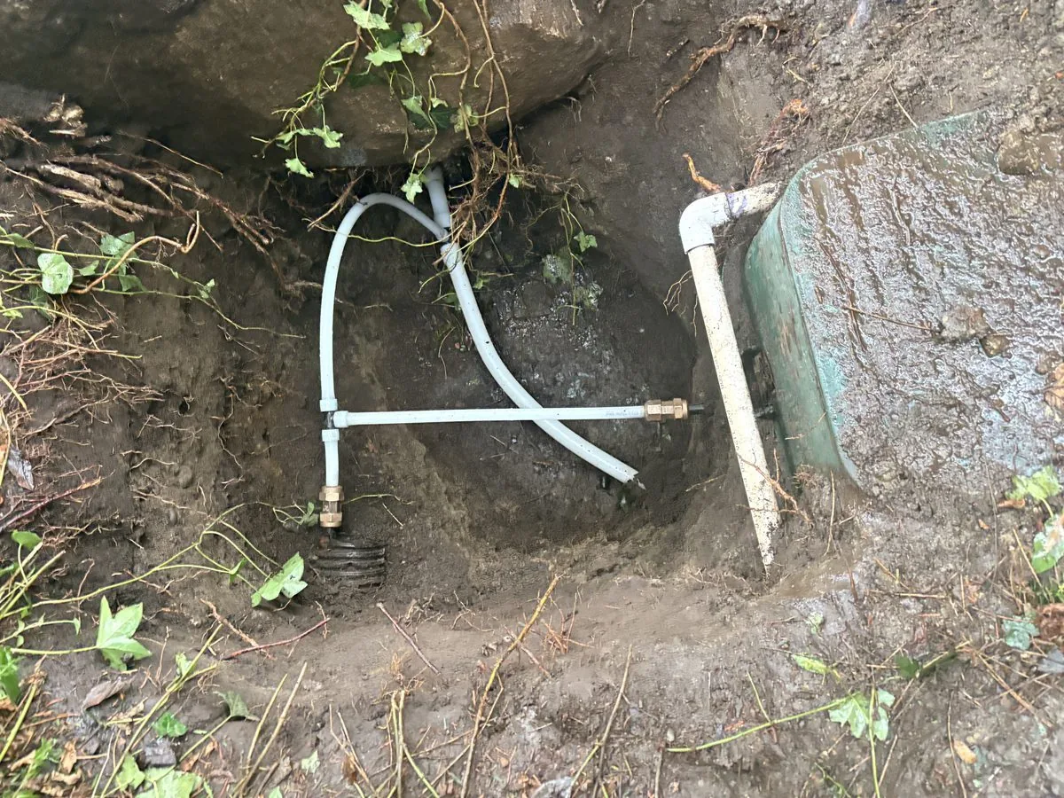Excavated water service line connection for a trenchless replacement